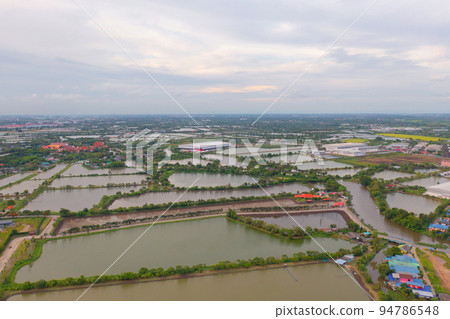 Aerial top view of industry factory in urban city town. Inventory import and export business commercial, Automobile and automotive industry distribution logistic transport with lake and river. 94786548