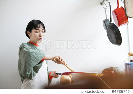 Young woman cooking 94786745