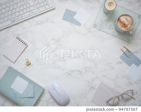 A workspace frame with small items in refreshing colors arranged on a marble desk 94787367