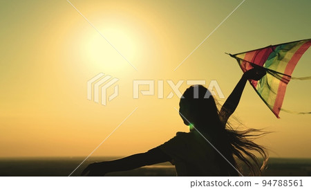 kite. colored rainbow kite hands girl with long hair. happy family. chidhood dream. girl park sunset playing with kite. child teenager journey. fantasy child. concept kite wind. play game nature. kite. colored rainbow kite hands girl with long hair. happy family. chidhood dream. girl park sunset playing with kite. child teenager journey. fantasy child. concept kite wind. play game nature. 94788561