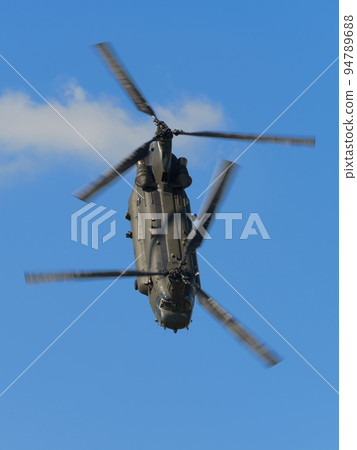 Royal Air Force Chinook HC2 helicopter flying in the blue sky 94789688