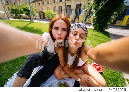 Beautiful women takes a picture with a wonderful park view 94789956