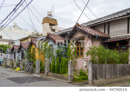 A western-style tenement house with an impressive triangular roof [Showacho area, Abeno-ku] 94790019