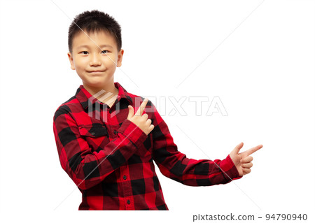 Kid with fingers presenting and pointing to the right, wearing red shirt isolated on white background 94790940