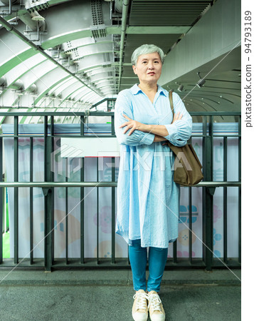 A 60-year-old mature Asian woman in public when she smiles and is full of self-confidence. A 60-year-old mature Asian woman in public when she smiles and is full of self-confidence. 94793189