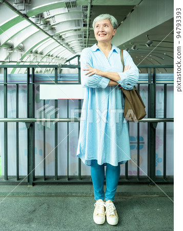 A 60-year-old mature Asian woman in public when she smiles and is full of self-confidence. A 60-year-old mature Asian woman in public when she smiles and is full of self-confidence. 94793393