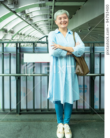 A 60-year-old mature Asian woman in public when she smiles and is full of self-confidence. A 60-year-old mature Asian woman in public when she smiles and is full of self-confidence. 94793400