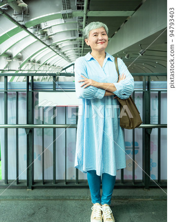 A 60-year-old mature Asian woman in public when she smiles and is full of self-confidence. A 60-year-old mature Asian woman in public when she smiles and is full of self-confidence. 94793403