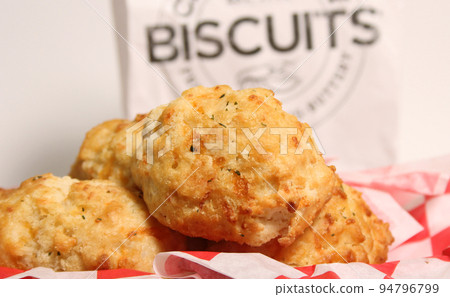 Fresh Garlic Cheese Biscuits With Biscuit Sign in Background Shallow DOF Fresh Garlic Cheese Biscuits With Biscuit Sign in Background Shallow DOF 94796799