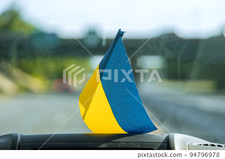 The flag of Ukraine in the car as a sign of support for Ukraine 94796978