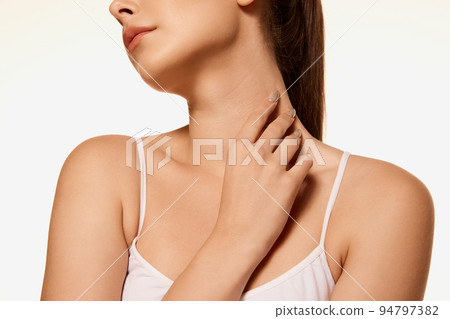 Cropped image of tender female body, neck, chin, collarbone isolated over white background. Skincare 94797382