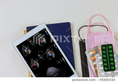 Using digital tablet, doctor checks results of echocardiography ultrasound the heart examination in order to prescribe a treatment that is effective for patient Using digital tablet, doctor checks results of echocardiography ultrasound the heart examination in order to prescribe a treatment that is effective for patient 94800380