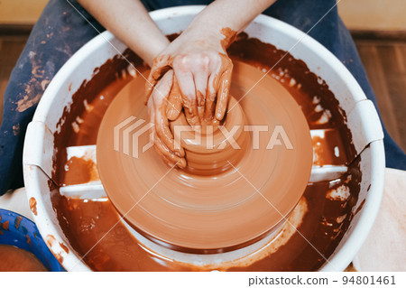 Potter forms clay products into future ceramic dishes. Process of creating clay products close-up.. 94801461