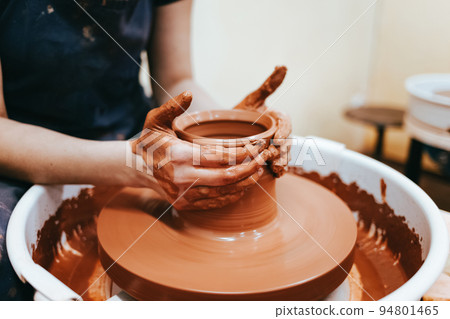 Woman is engaged in pottery. Potter in the process of creating a clay product.. 94801465