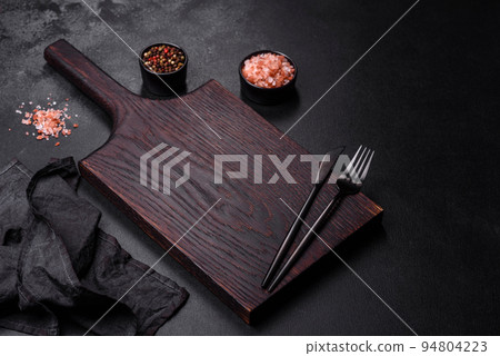 Empty black plate over dark stone background with free space. Top view Empty black plate over dark stone background with free space. Top view 94804223