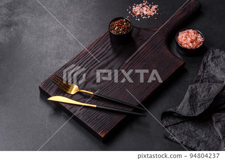 Empty black plate over dark stone background with free space. Top view Empty black plate over dark stone background with free space. Top view 94804237