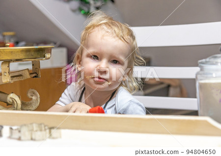 Portrait of a cute boy with his mouth dirty from tasting cookies. Portrait of a cute boy with his mouth dirty from tasting cookies. 94804650