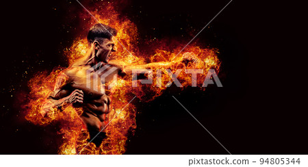Fighter man with chain on hand punching in fire 94805344