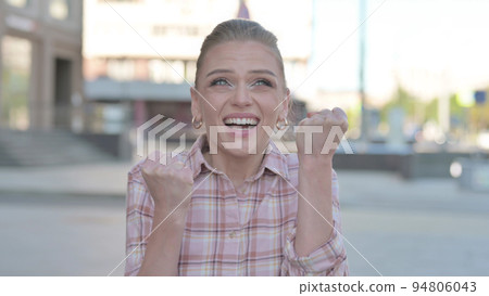 Portrait of Excited Young Woman Celebrating Success Outdoor Portrait of Excited Young Woman Celebrating Success Outdoor 94806043
