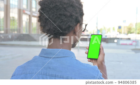 Young African Man Using Smartphone with Green Screen Outdoor Young African Man Using Smartphone with Green Screen Outdoor 94806385