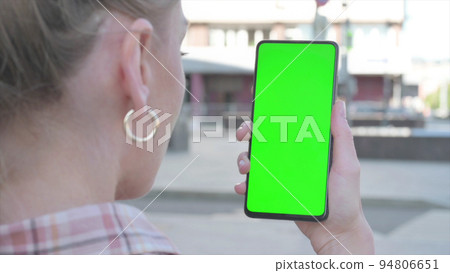 Close Up of Young Woman Using Smartphone with Green Screen Outdoor 94806651