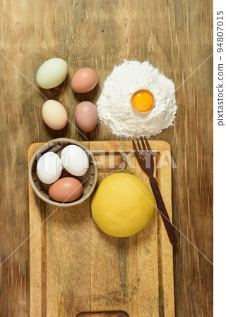 Egg noodle dough bun, with ingredients on the table. Egg noodle dough bun, with ingredients on the table. 94807015