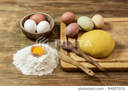Egg noodle dough bun, with ingredients on the table. Egg noodle dough bun, with ingredients on the table. 94807016