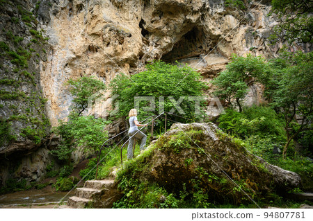 Person walks in gorge, Kislovodsk, Russia. Mountain landscape with Honey Waterfalls 94807781