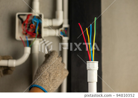 Electrician repair wire in PVC Conduit , renovate home . 94810352