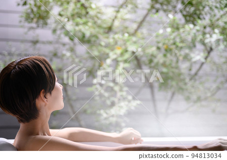 A woman relaxing in a bathtub Faceless 94813034