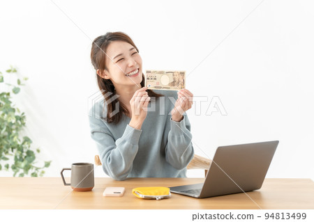 A woman with a 10,000 yen note A woman with a 10,000 yen note 94813499
