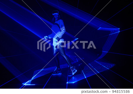 Woman is using virtual reality headset to access in metaverse. 94815586