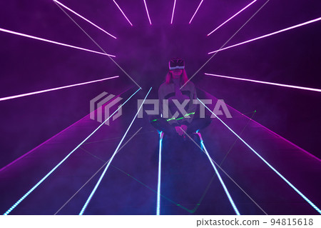 Woman is using virtual reality headset to access in metaverse. 94815618