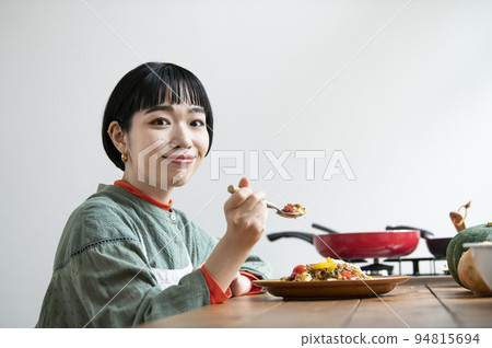 Young woman eating gapao rice 94815694