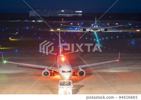 Airport at night Towing car pushing an airplane Chitose city, Hokkaido Airport at night Towing car pushing an airplane Chitose city, Hokkaido 94816665
