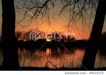 Sunset with water and trees out in the country 94818378