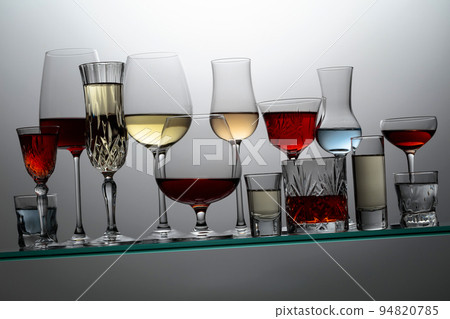 Alcoholic drinks on a tilted glass shelf. Alcoholic drinks on a tilted glass shelf. 94820785