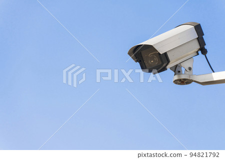 Surveillance camera. surveillance camera. Blue sky background. 94821792