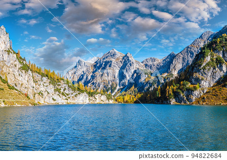 Sunny autumn alpine Tappenkarsee lake and rocky mountains above, Kleinarl, Land Salzburg, Austria. Sunny autumn alpine Tappenkarsee lake and rocky mountains above, Kleinarl, Land Salzburg, Austria. 94822684