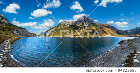 Sunny autumn alpine Tappenkarsee lake and rocky mountains above, Kleinarl, Land Salzburg, Austria. Sunny autumn alpine Tappenkarsee lake and rocky mountains above, Kleinarl, Land Salzburg, Austria. 94822685