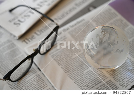 Glass globe and English newspaper World news image (September 2022) 94822867