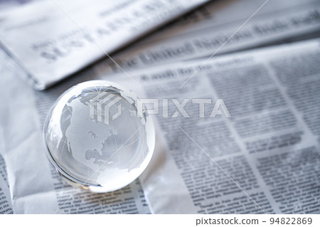 Glass globe and English newspaper World news image (September 2022) 94822869
