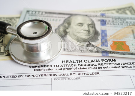 Health claim form with stethoscope and US dollar banknotes, insurance accident medical concept. 94823217