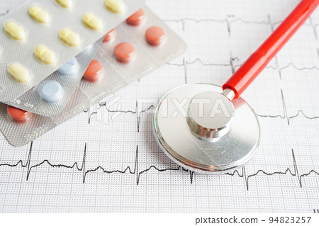 Stethoscope on electrocardiogram (ECG) with drug, heart wave, heart attack, cardiogram report. Stethoscope on electrocardiogram (ECG) with drug, heart wave, heart attack, cardiogram report. 94823257