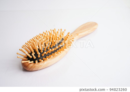 Hair loss fall with comb brush isolated on white background. Hair loss fall with comb brush isolated on white background. 94823260