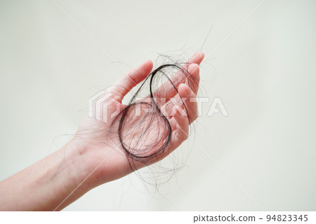 Asian woman have problem with long hair loss attach in her hand. Asian woman have problem with long hair loss attach in her hand. 94823345