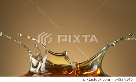 Freeze Motion Shot of Flowing Oil on Gradient Black Background 94824146
