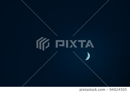 Crescent moon in a cloudless night sky 94824505