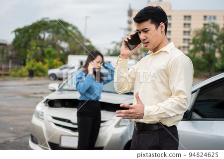 Two drivers call insurance after a car accident before taking pictures and sending insurance. Online car accident insurance claim idea after submitting photos and evidence to an insurance company. 94824625