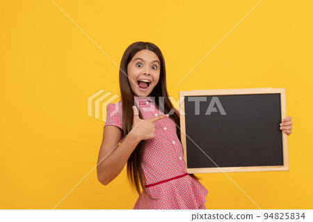 amazed kid hold school blackboard for copy space showing thumb up, announcement 94825834